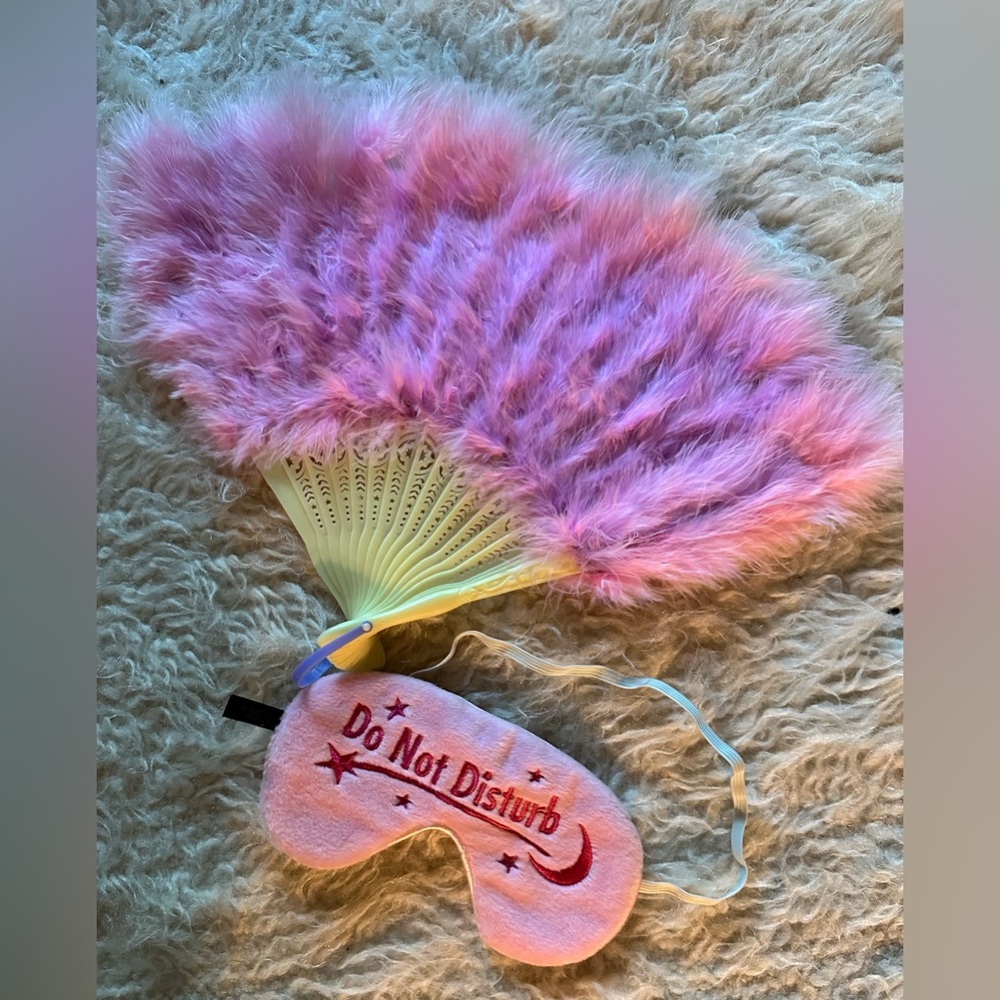 Pink feather fan and “do not disturb” sleeping eye mask